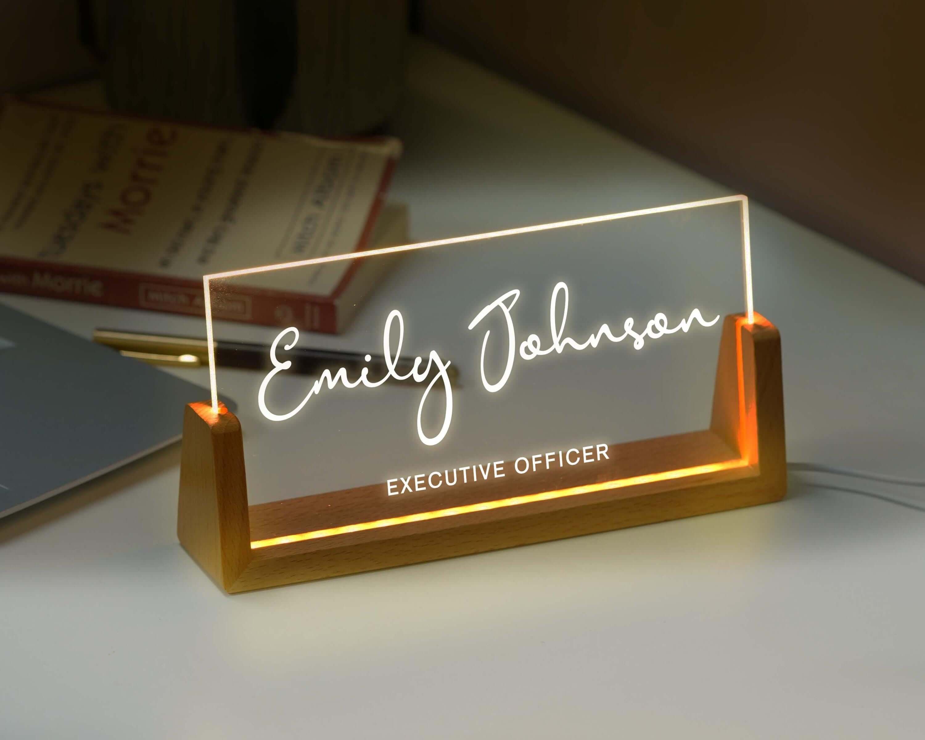 an illuminated business name sign on a desk