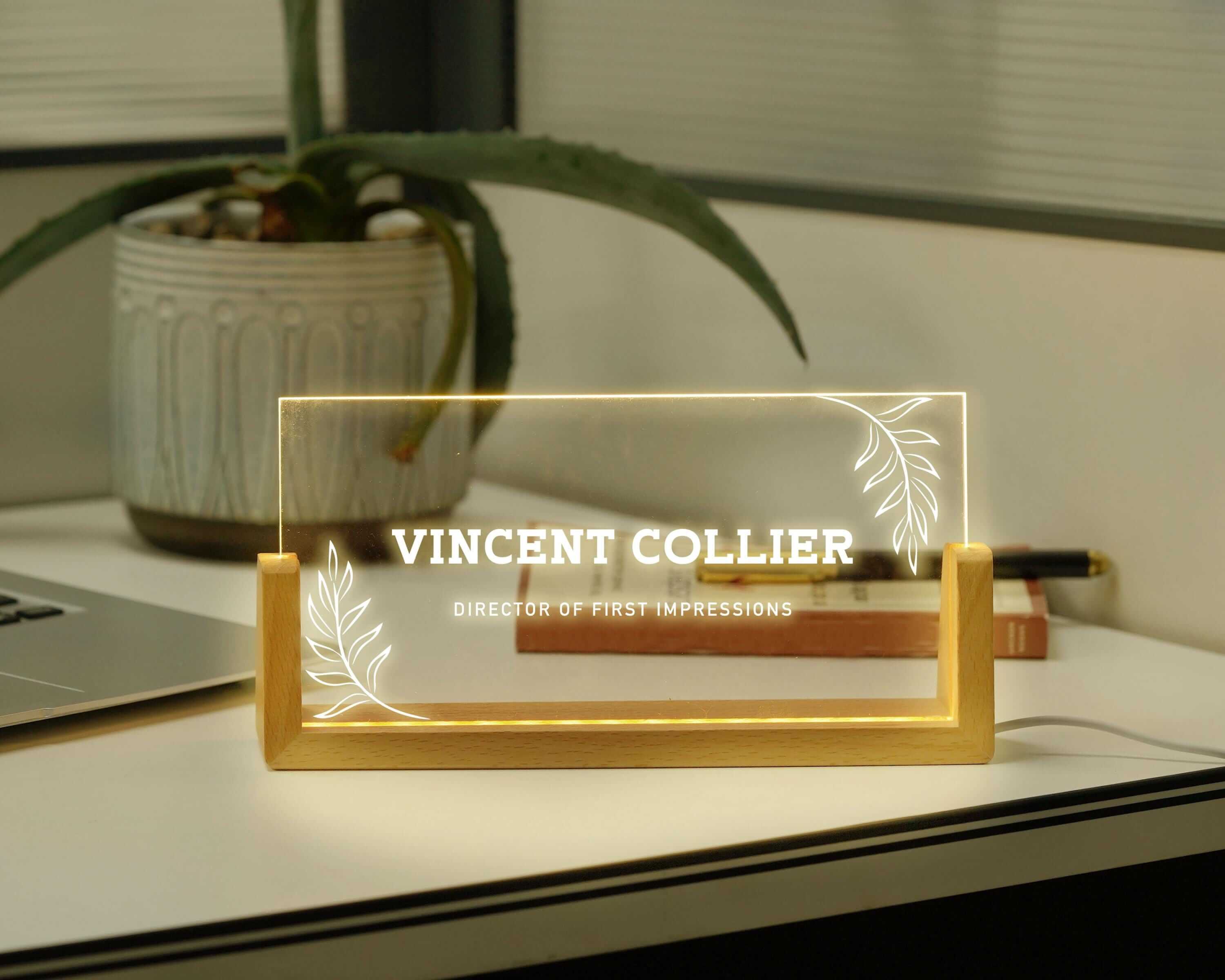 a glass plaque sitting on top of a desk next to a laptop