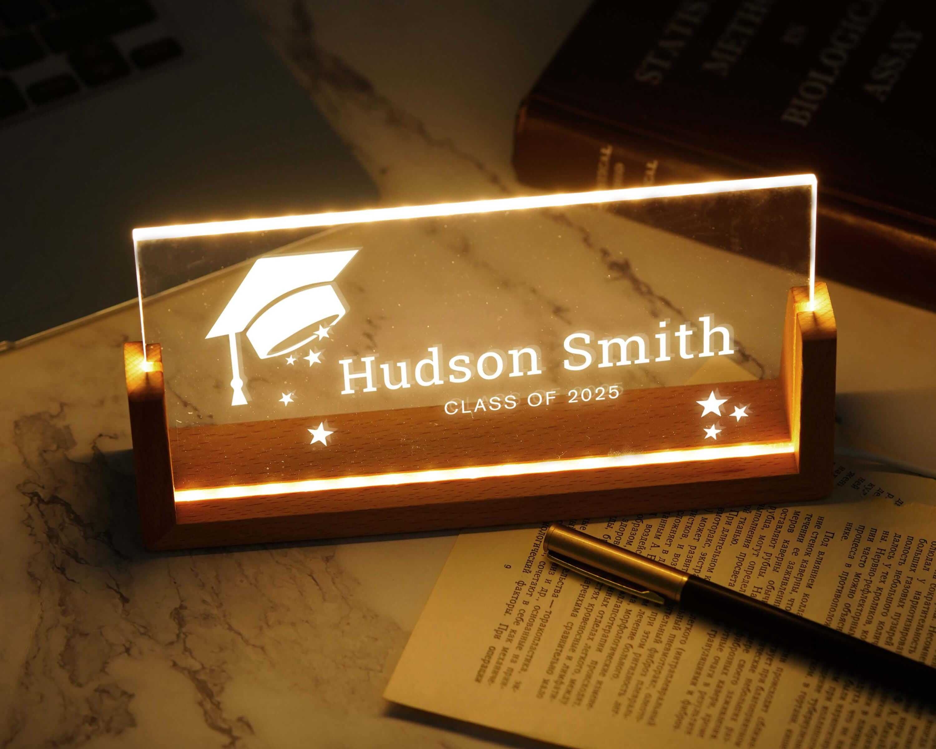 a glass plaque with a graduation cap on it