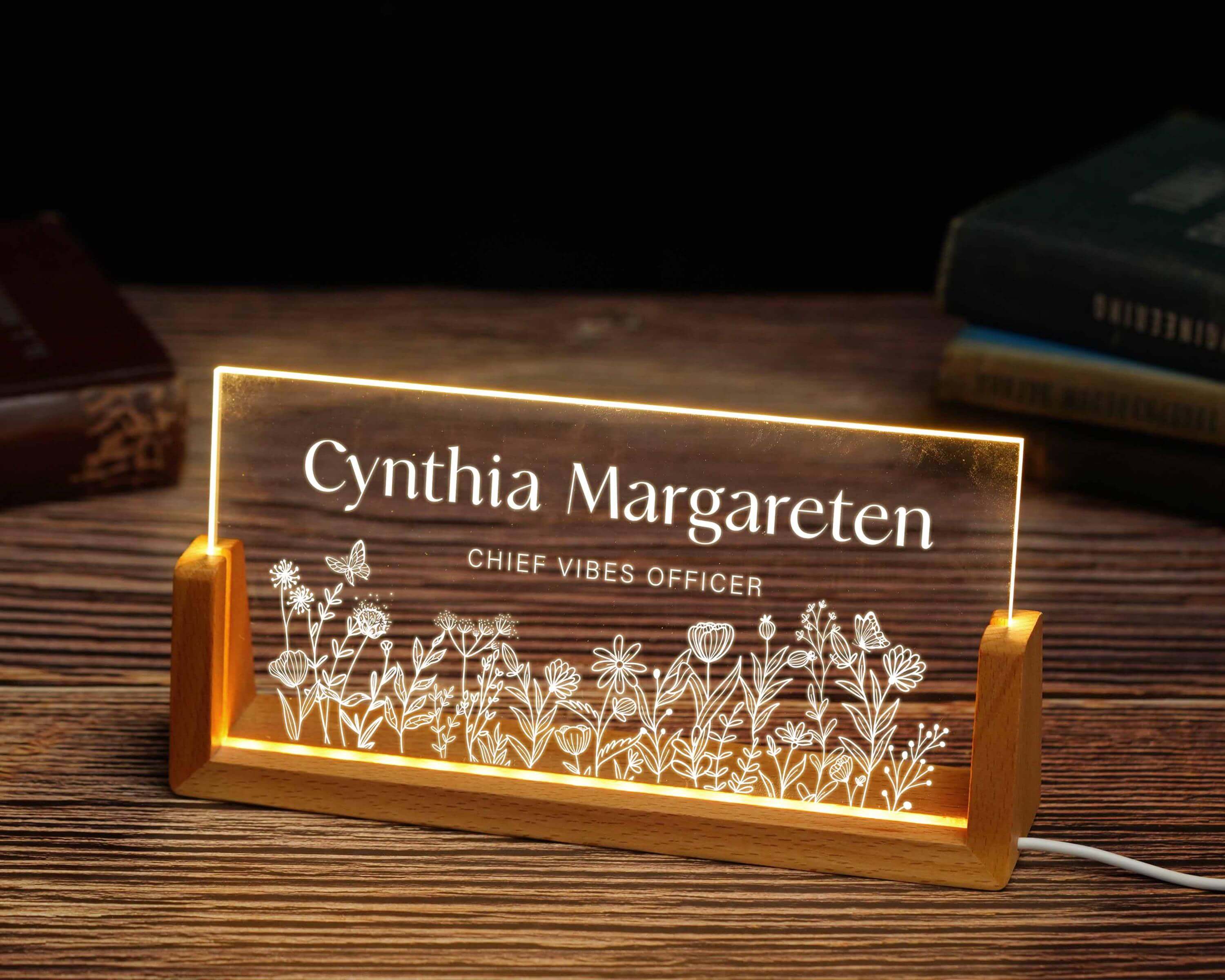 a lighted sign with a picture of flowers on it