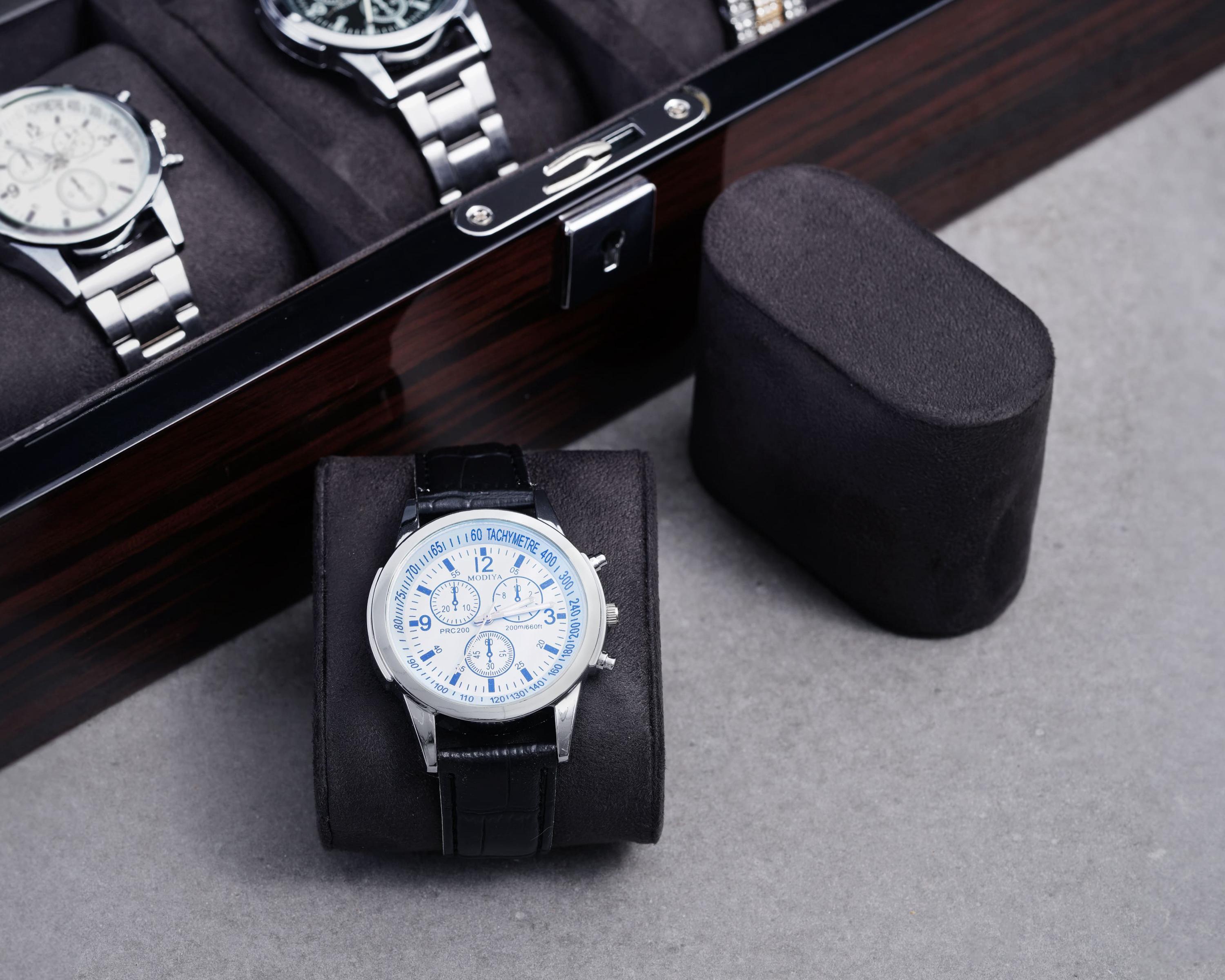 a watch sitting in a box next to a watch case