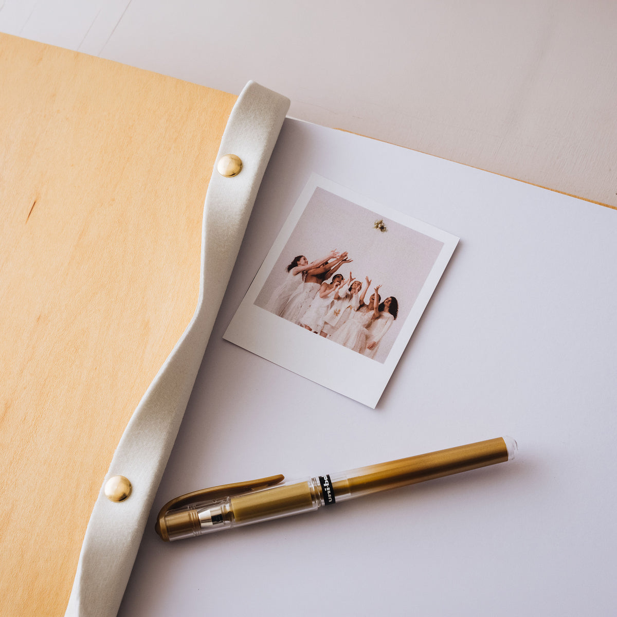 Wood guest book cover with white leather spine and gold pen
