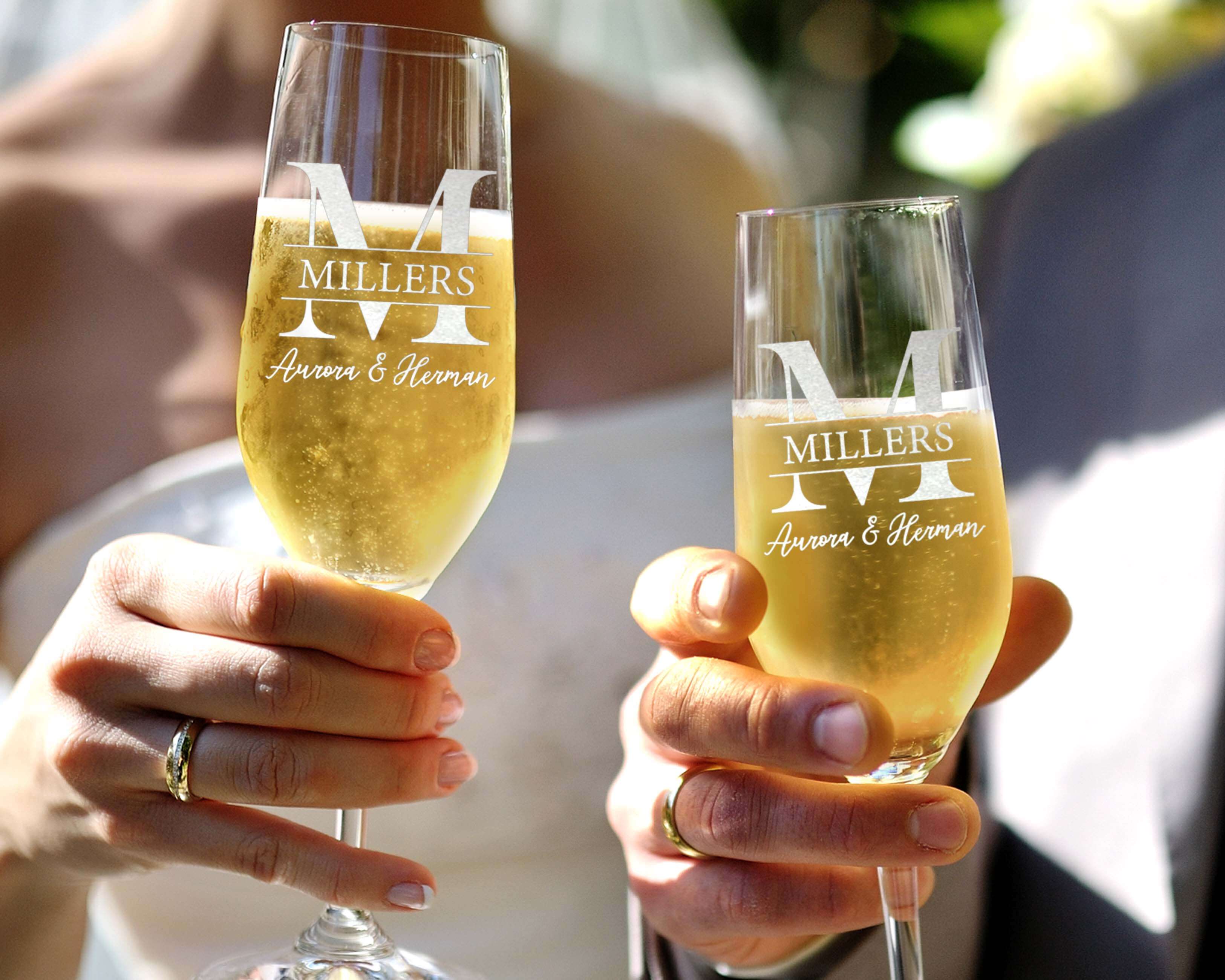 The bride and groomsmen hold our Custom Wedding Toasting Flutes with name. The perfect couple wine glasses for wedding day.