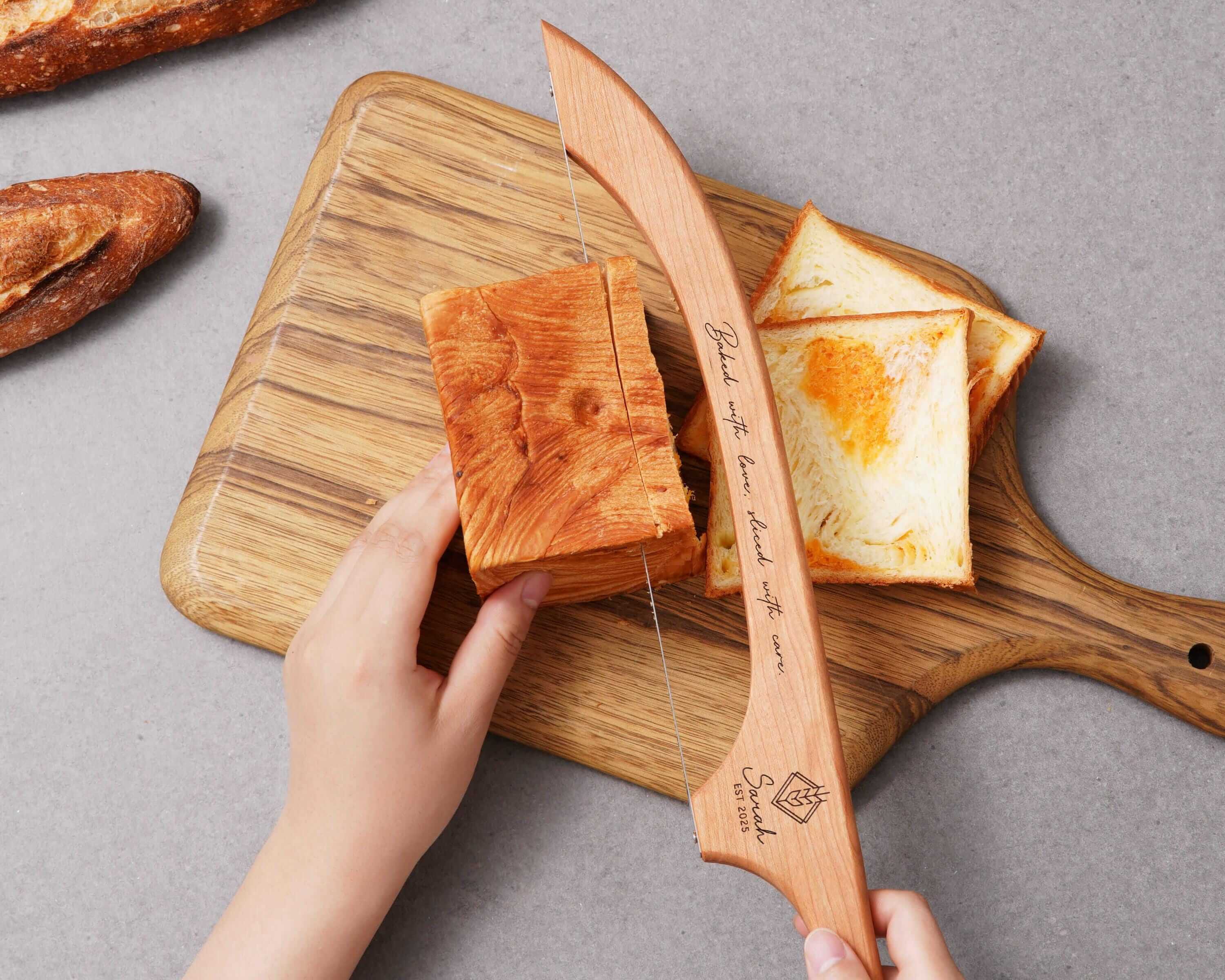 a person cutting bread on a cutting board