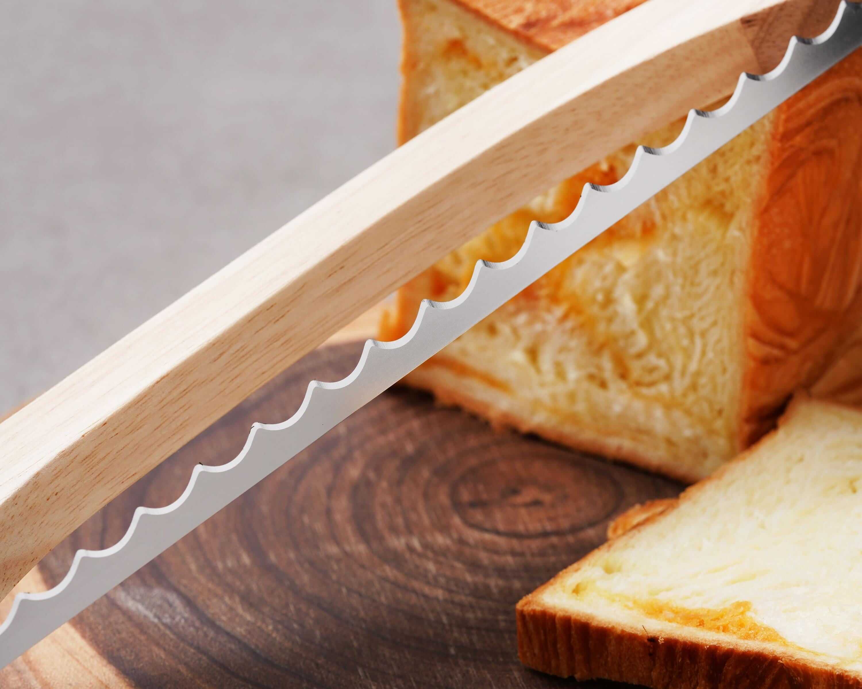 a knife and a loaf of bread on a cutting board