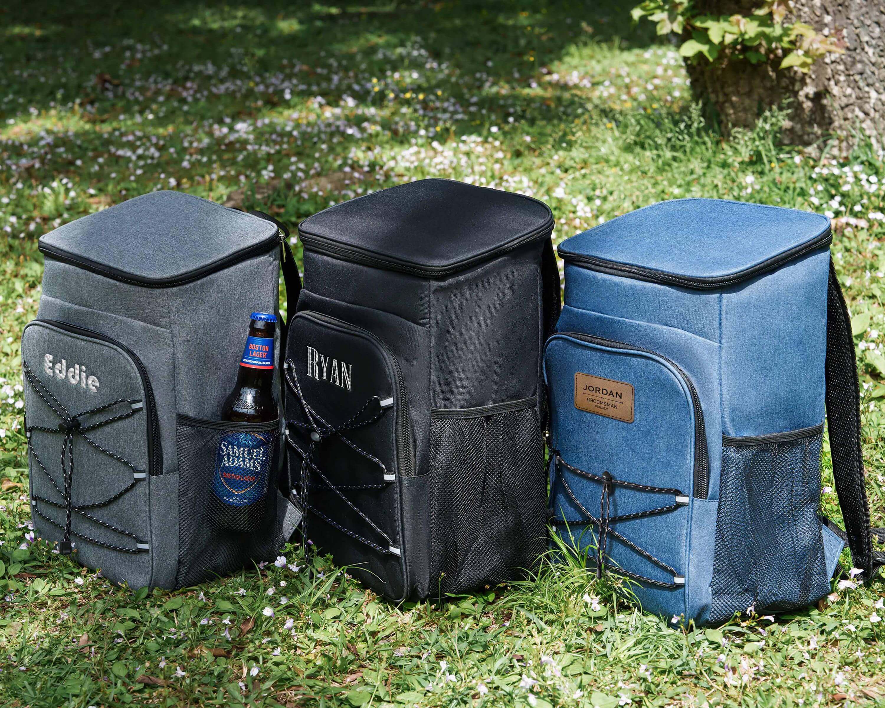 a group of cooler bags sitting on top of a grass covered field