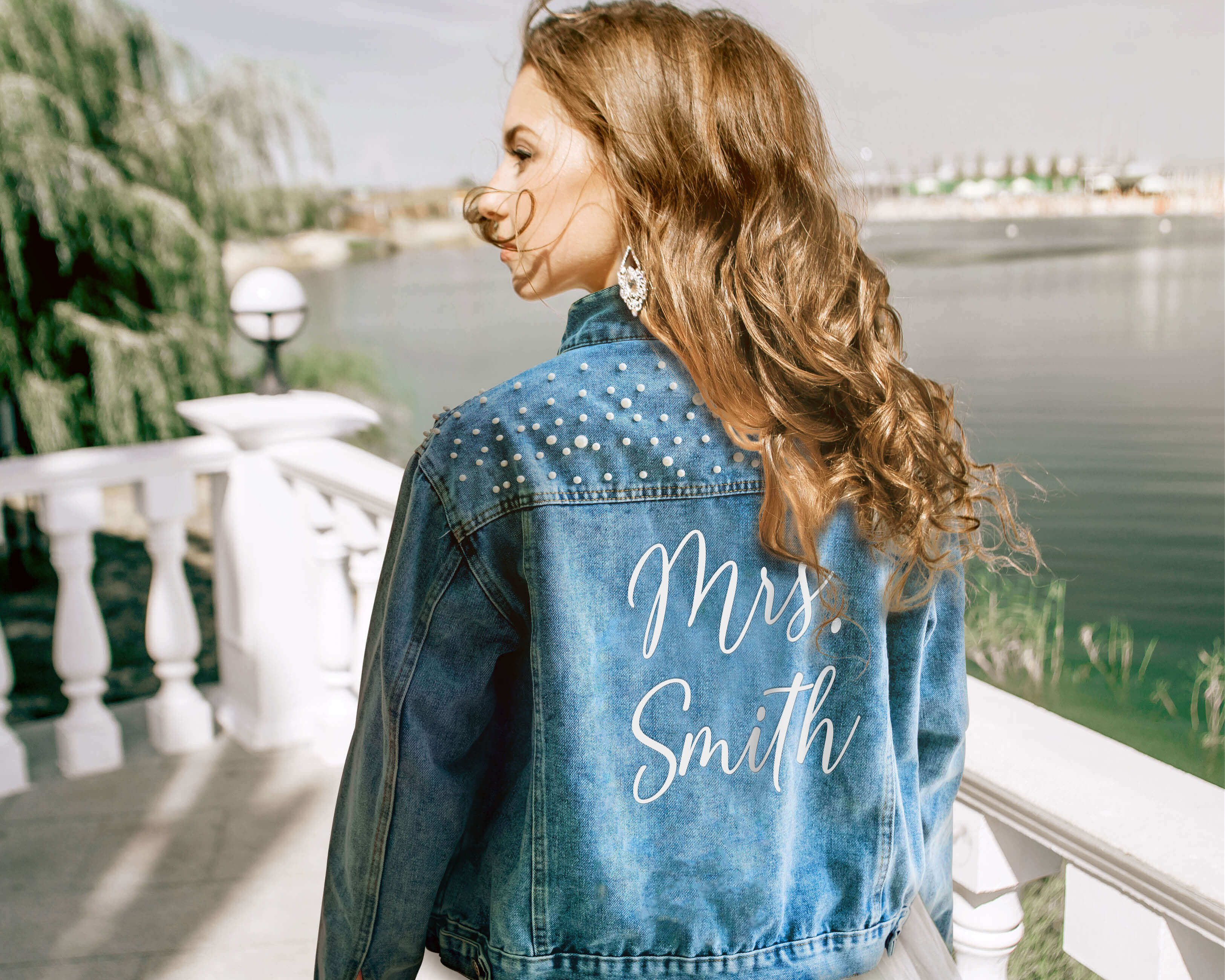 A beautiful bride wear a custom bride jean jacket with custom text on her wedding day.