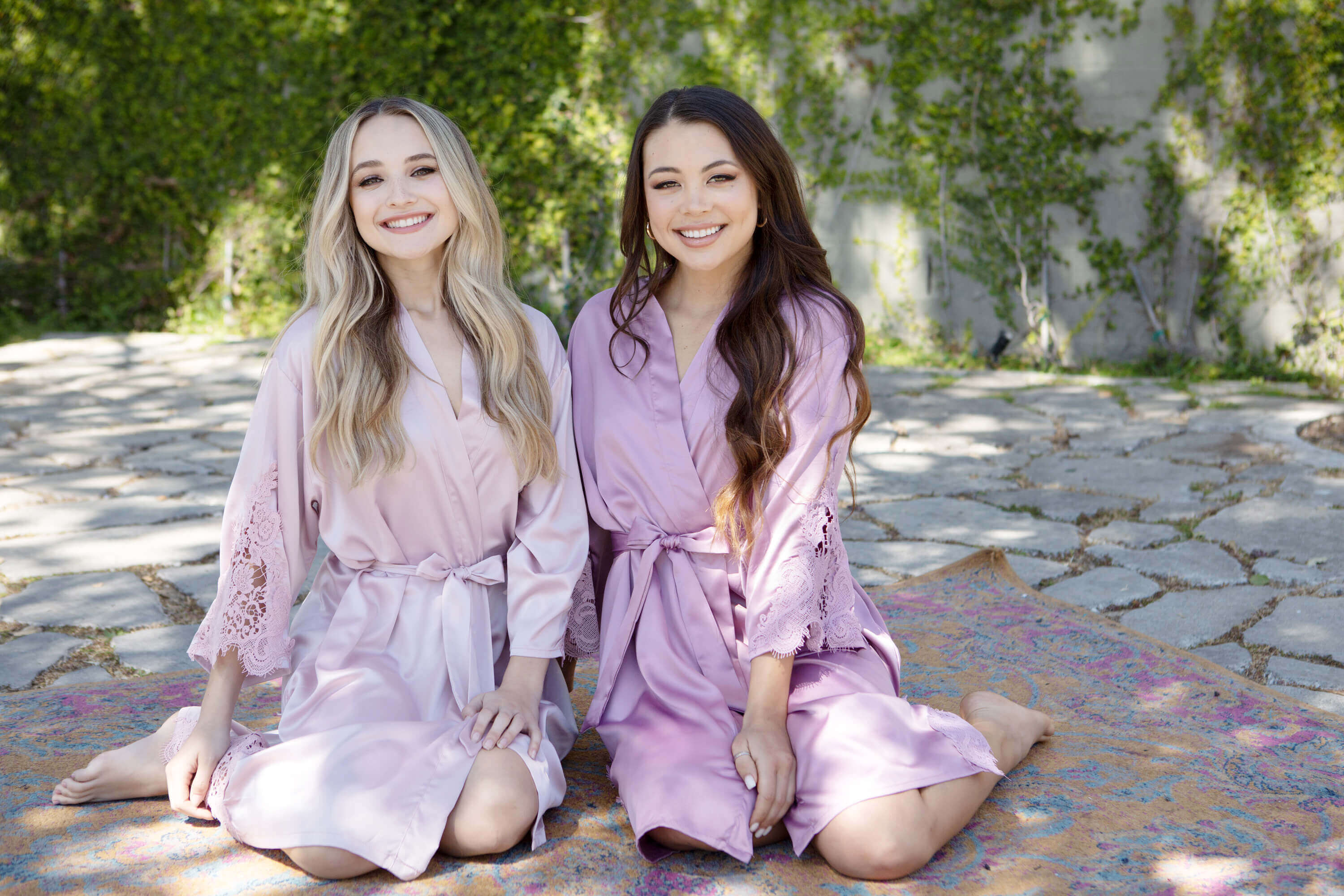 Personalized Lace Bridal Robe - Two beautiful models dressed in mauve and nude pink bridal robes with lace trim in preparation for a bachelorette party, wedding or any fun occasion.