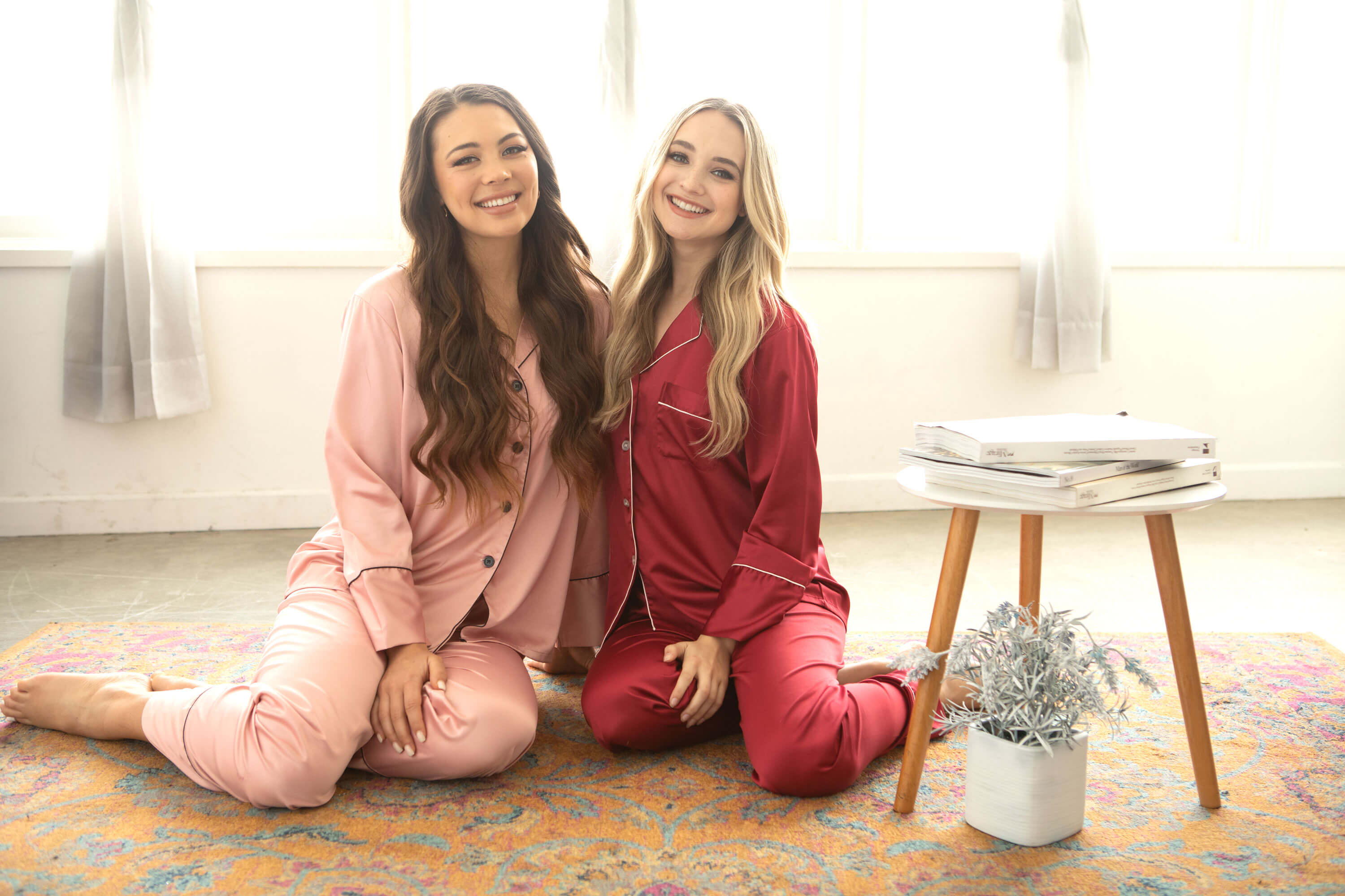 Personalized Bridal Pajamas - Two beautiful models dressed in dusty rose and burgundy bridal party pajama pants set with monogram design in preparation for a bachelorette party, wedding or any fun occasion.