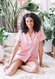 A model wear Blush Bridesmaid Pajamas Short Set in preparation for a bachelorette party, wedding or any fun occasion.