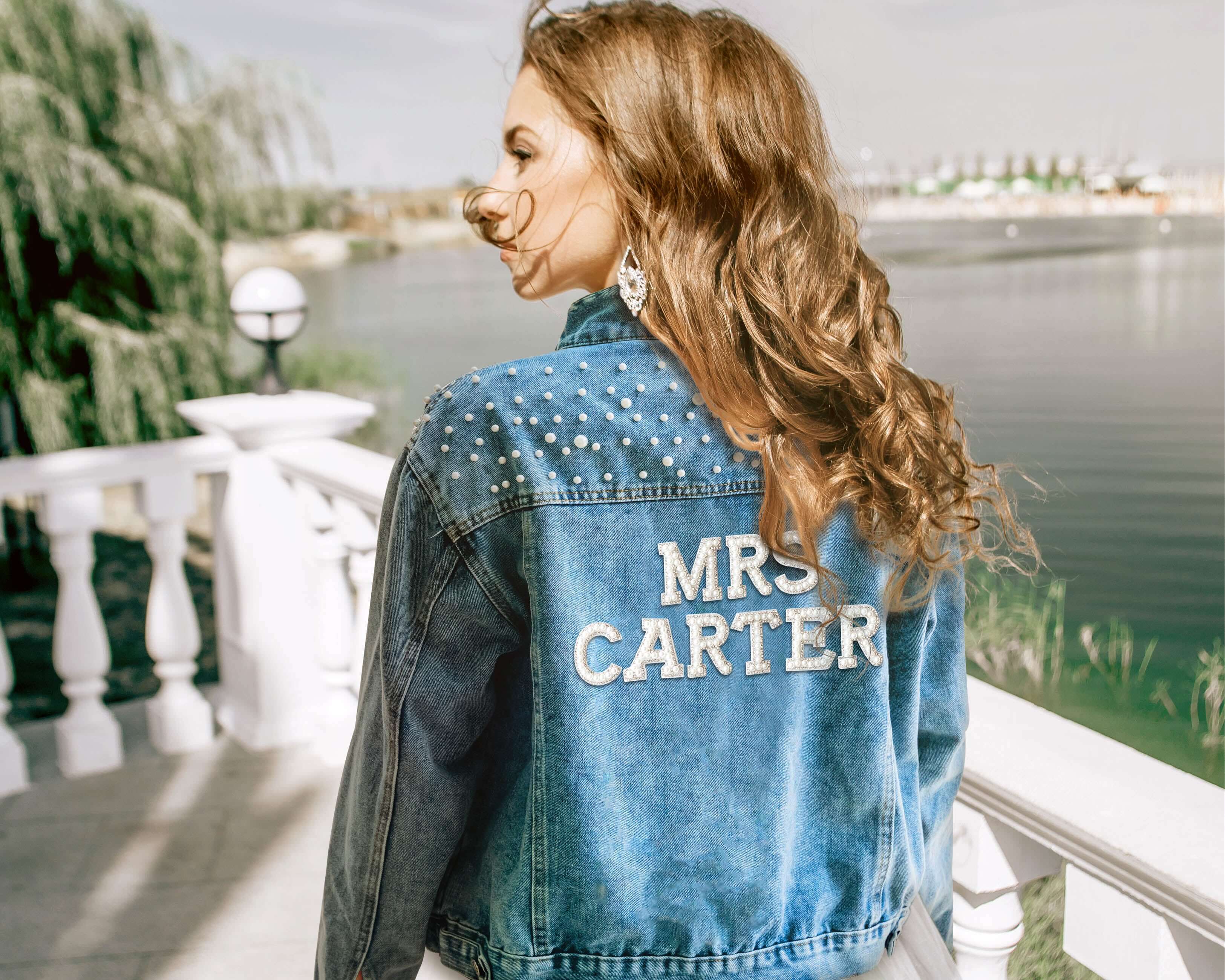 A beautiful bride wore a custom bride jean jacket with pearls on her wedding day.