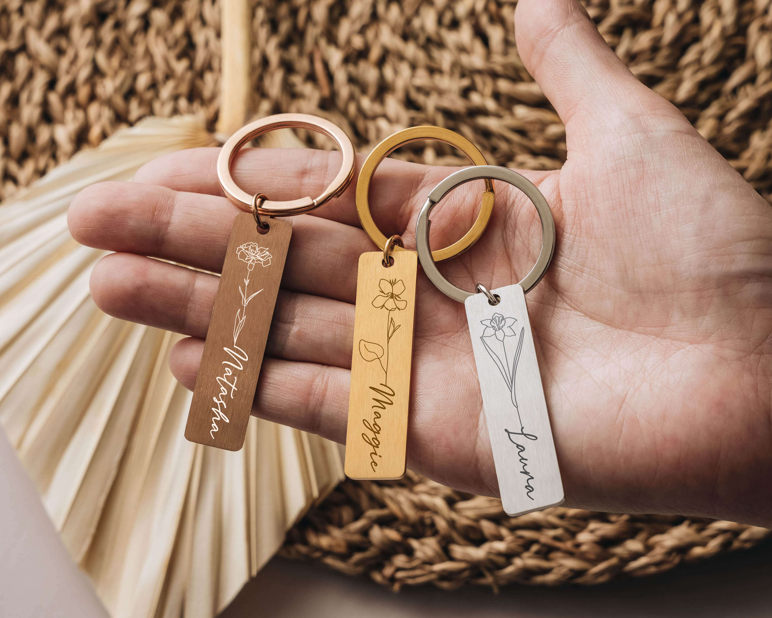 Gold, Rosegold and Silver Personalized Keychains with birth flower image and name.